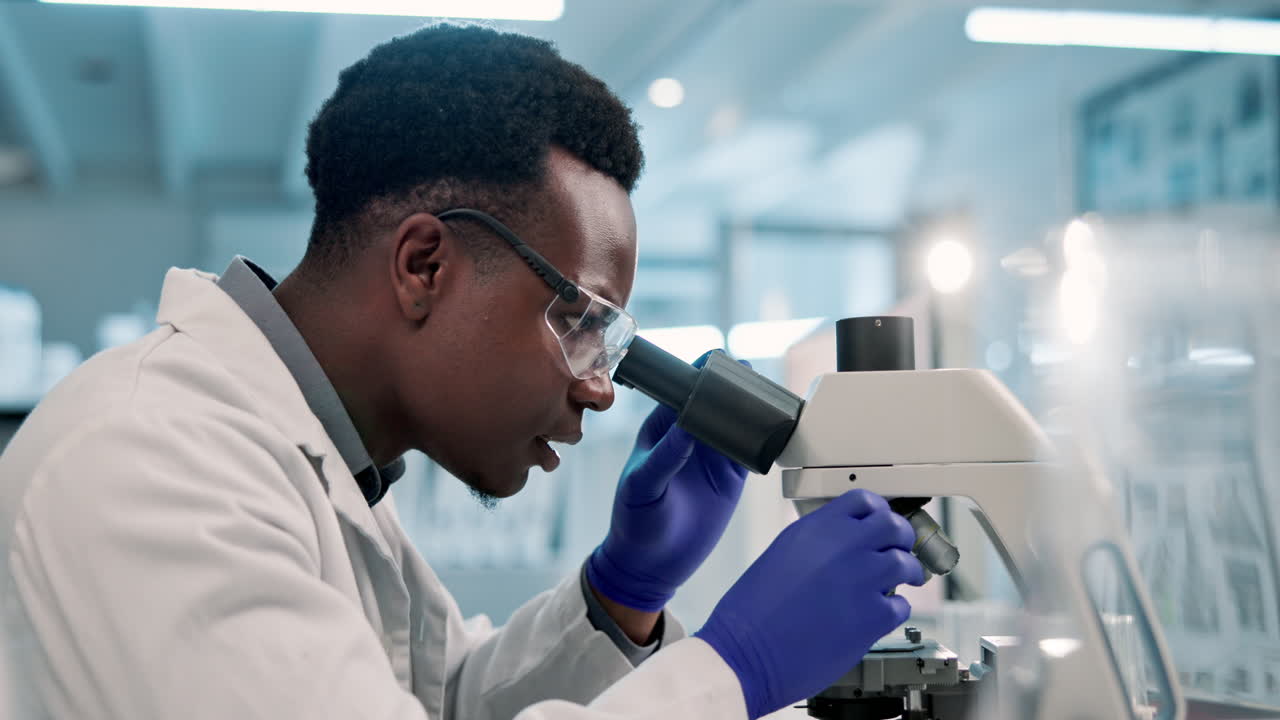 Scientist working with a microscope in a laboratory