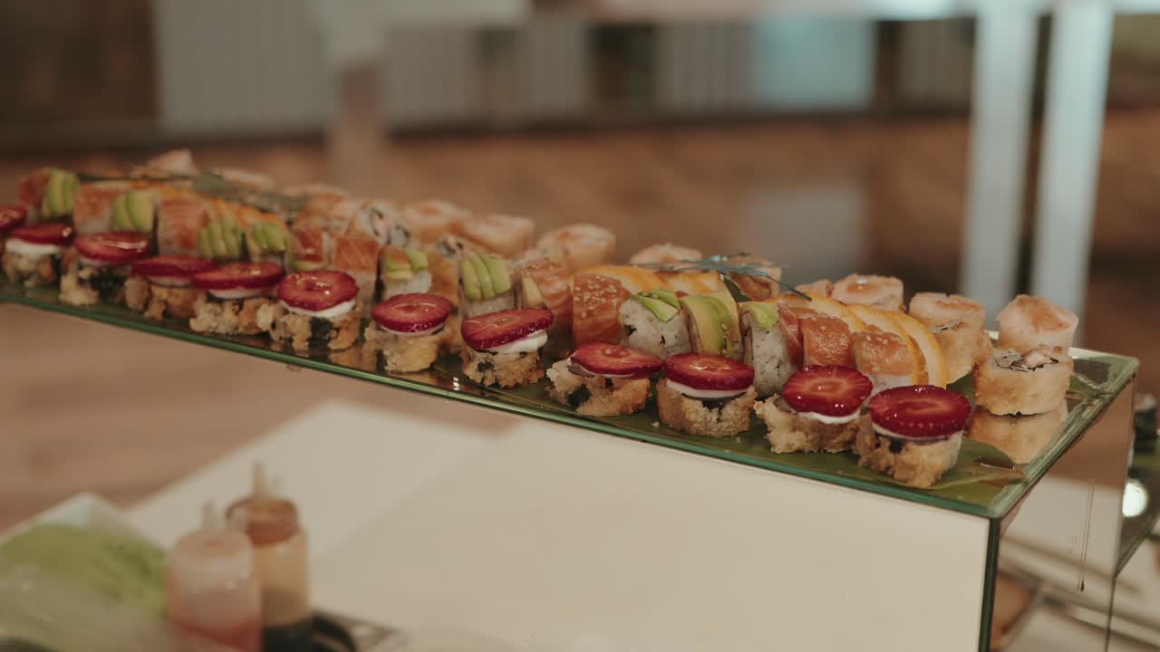 creative sushi roll assortment with strawberries avocado and fish served on glass pedestal