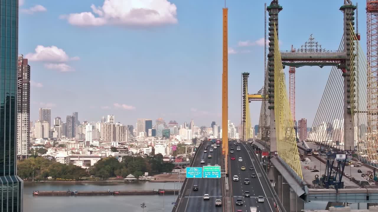 View of Bangkok's skyline with traffic on a bridge during daytime