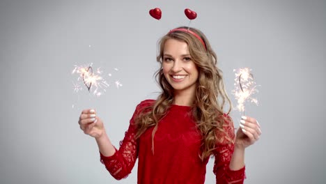 beautiful woman having fun with burning sparklers