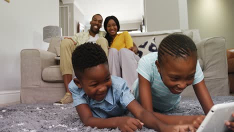 children using digital tablet while couple smiling in background 4k