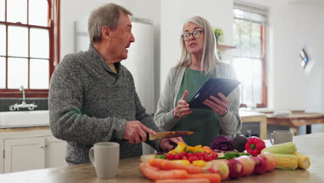 Senior-couple-in-kitchen,-cooking-with-tablet