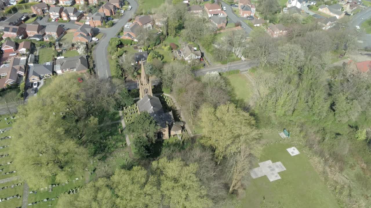 Countryside village aerial view above farmland fields typical British homes townscape descending birds eye