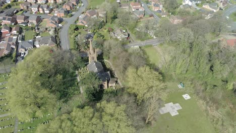 countryside village aerial view above farmland fields typical british homes townscape descending birds eye