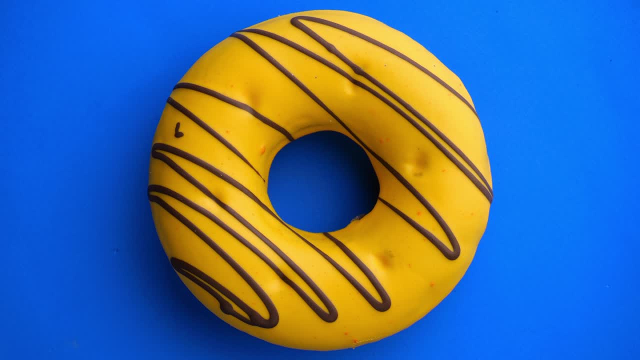 Doughnut glazed close-up. Seamless looping.