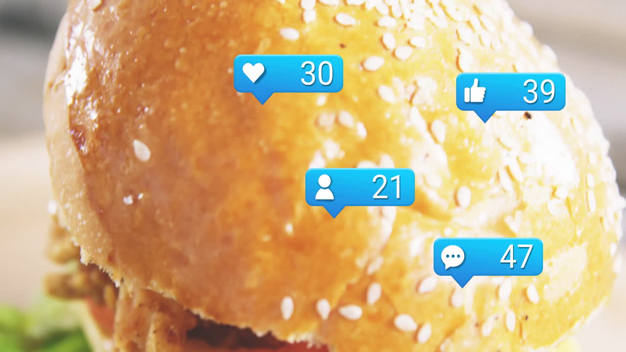 Animation of burger with social media icons displaying likes, comments, followers