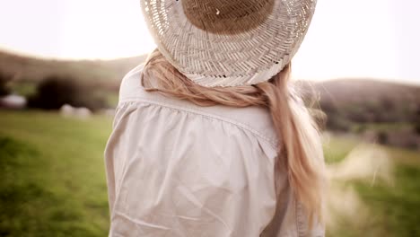 beautiful teen girl with blond hair walking in the country