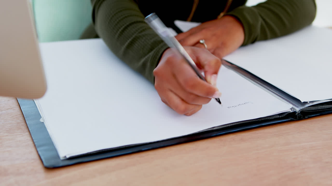 Female executive writing on a document at desk in the office 4k