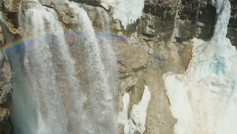 Eisbedeckter-Wasserfall,-Sonnenlicht-Bricht-Sich-In-Wassertropfen,-Schwenk-Hinein