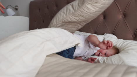 family spending free time at home. cheerful family having fun with their daughters on the bed