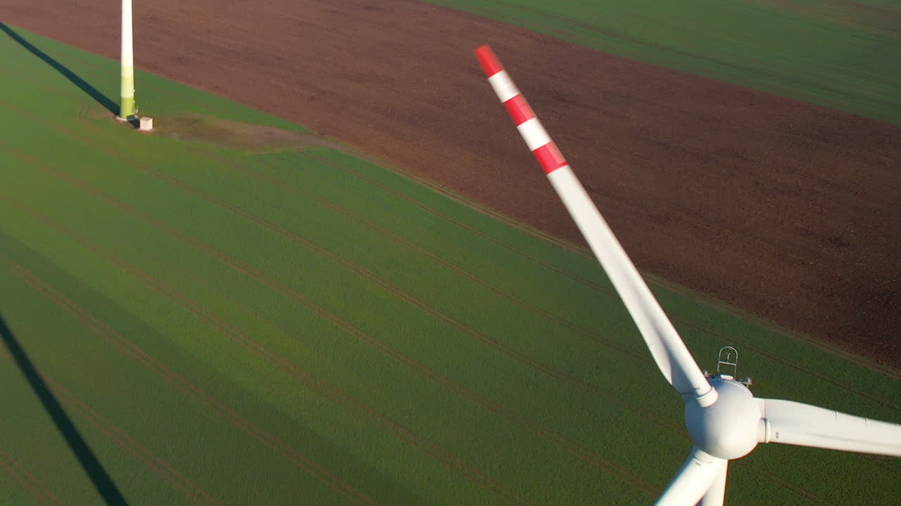 Wind power turbines generating clean renewable energy for sustainable development - High angle aerial close-up