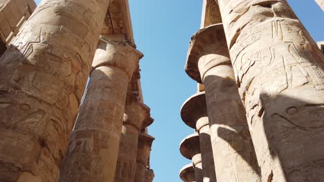 hieroglyphs, carvings, inscriptions and symbols depicted on papyrus columns antique pillars of great hypostyle hall in karnak temple complex luxor