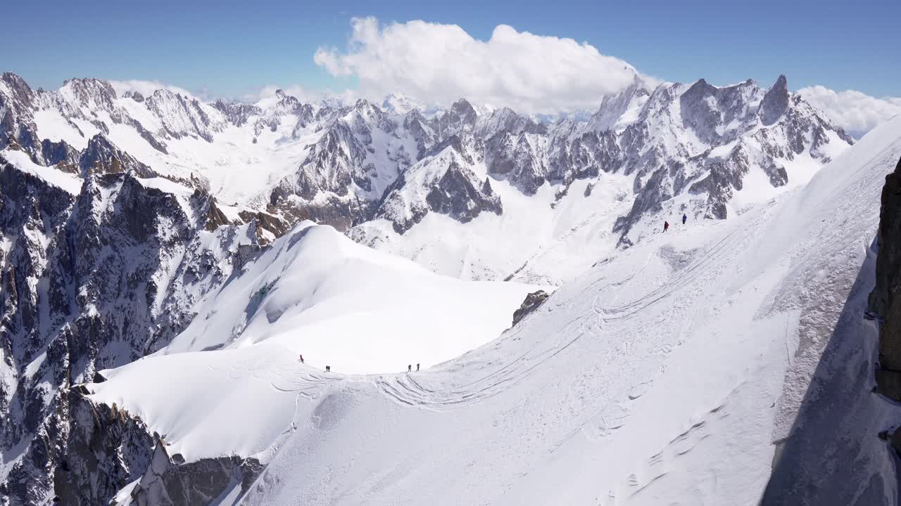 a group of climbers climbs the snow-capped peaks of the alpine mountains. Mont Blanc mountain