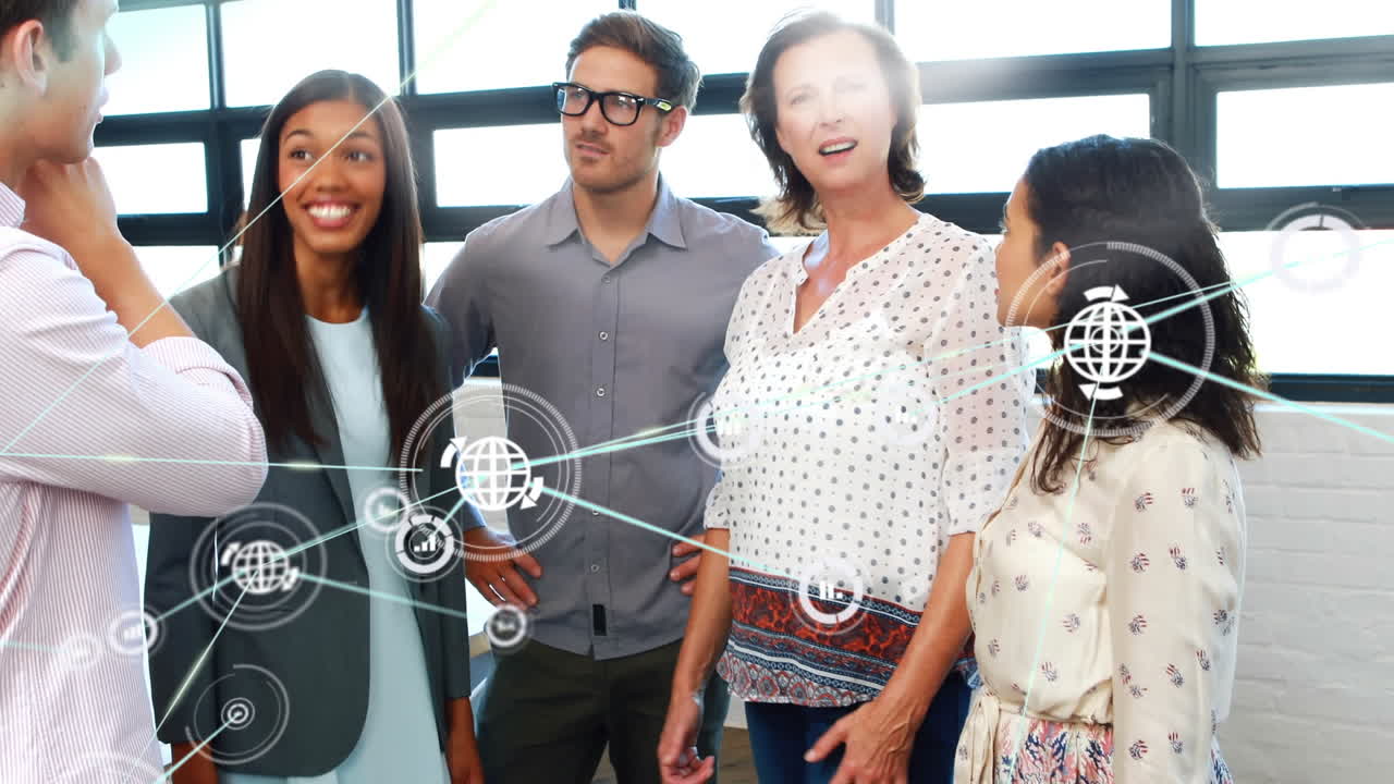 Animation of network of digital icons over diverse colleagues discussing together at office
