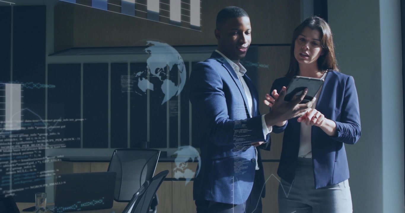 Colleagues holding tablet and swiping, reviewing business data as animated globes overlaying scene