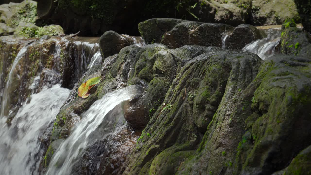 Waterfall Sumampan mask face stone design artificial water cascade artwork Bali landmark