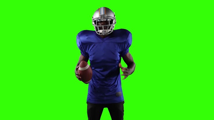 African American football player on green screen background.