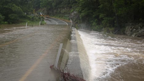 mudgeeraba, gold coast 02 january 2024 - close shot of flooding across mudgeeraba creek bridge causing road closure