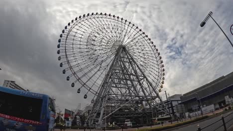 time-lapse of a ferris wheel against cloudy skies