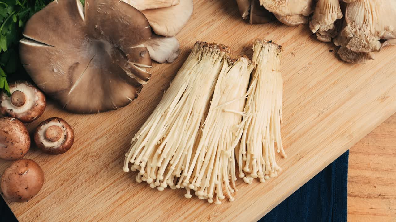 Variety of Mushrooms on a Wooden Cutting Board