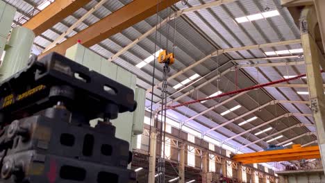 production area on manufacturing factory with stack of iron molding, overhead crane and big machine