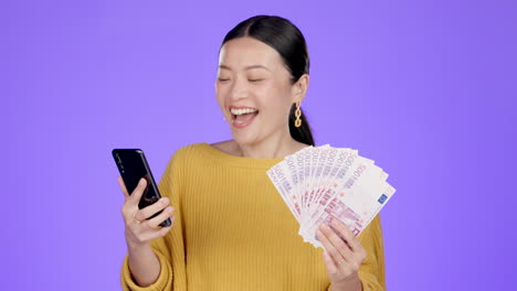 phone, money and winning asian woman in studio