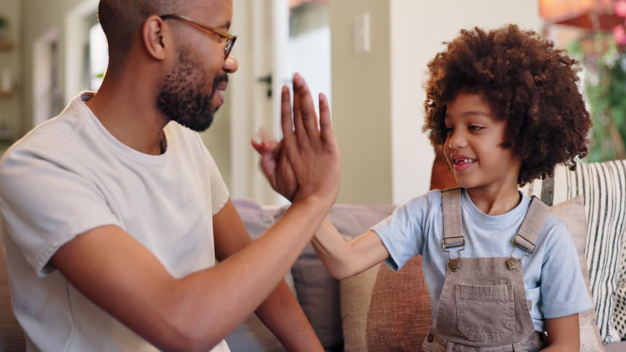 Father and son high five at home