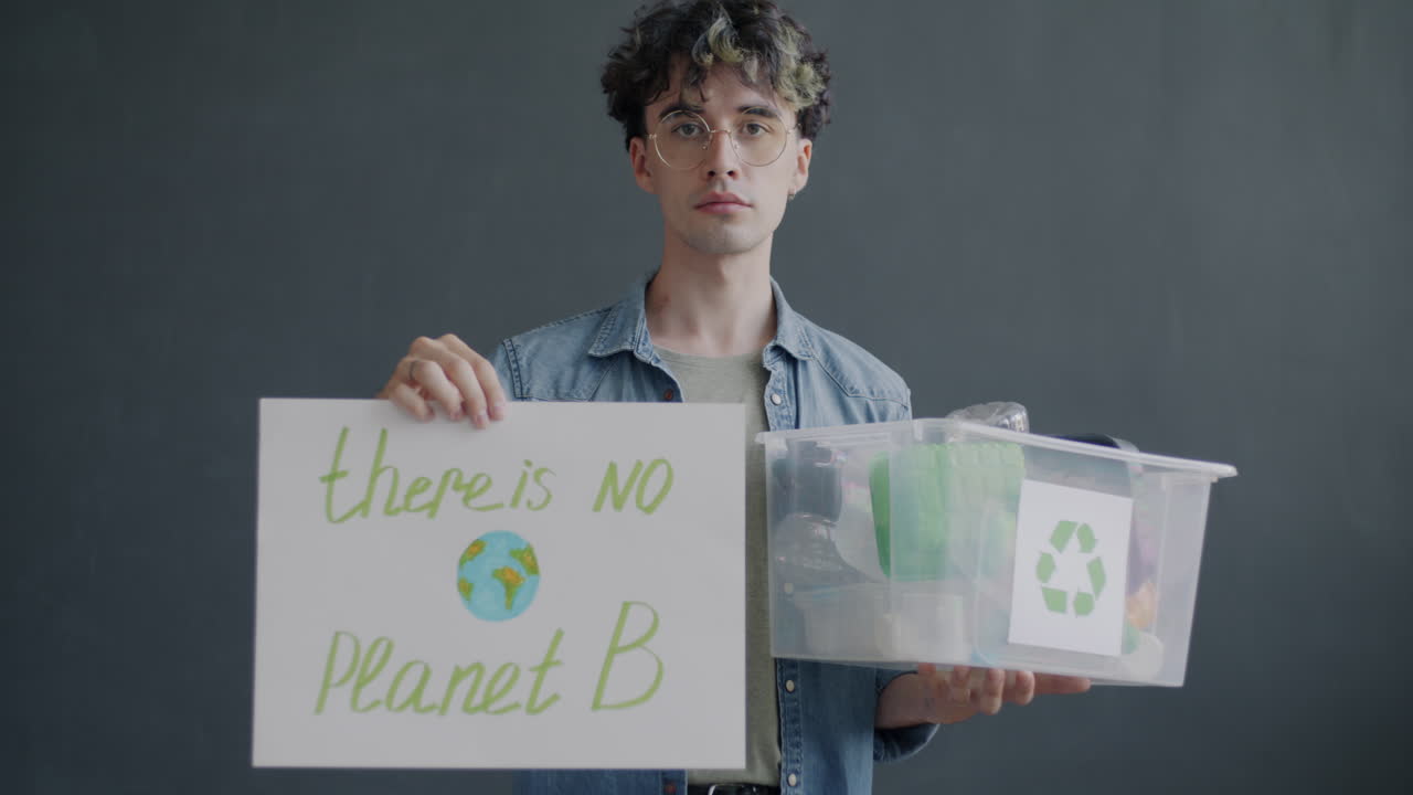 Man Holding Sign and Recycling Box, 'There is No Planet B'