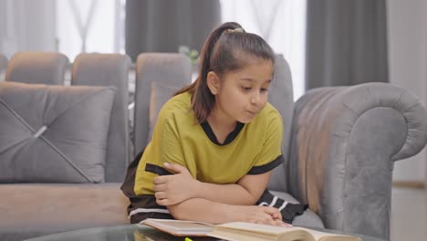 indian kid girl studying at home with concentration