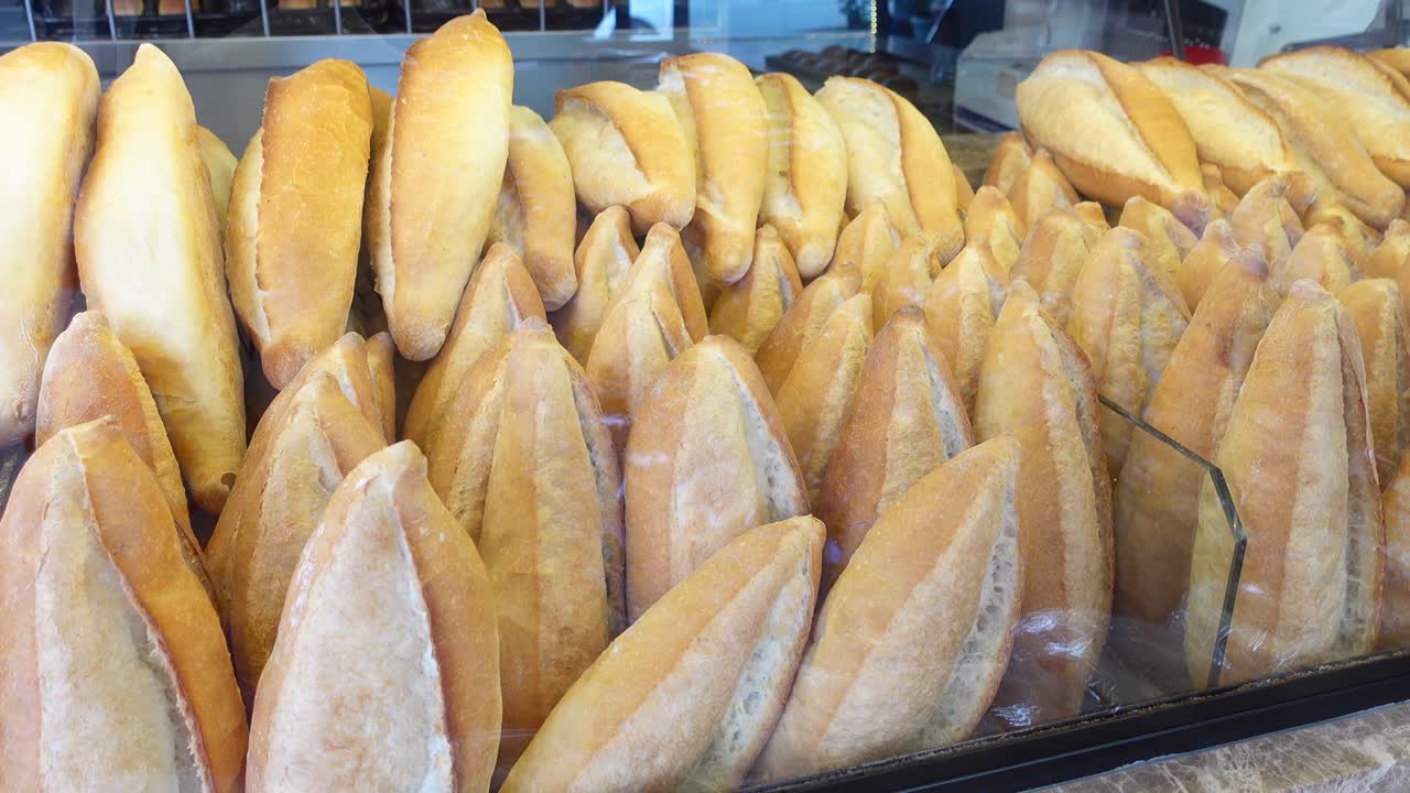 Close-up of freshly baked bread loaves in a bakery display case
