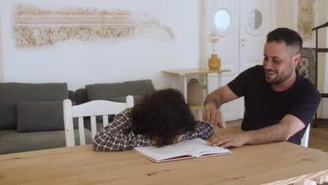 cheerful son and father trying to do homework.