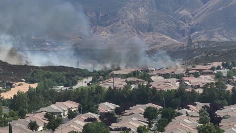 large-san-jancinto-wildlife-area-wildfire-over-sun-lakes-community-in-banning-california-fire-near-homes-with-emergency-cehicals-in-view-AERIAL-TELEPHOTO-PAN