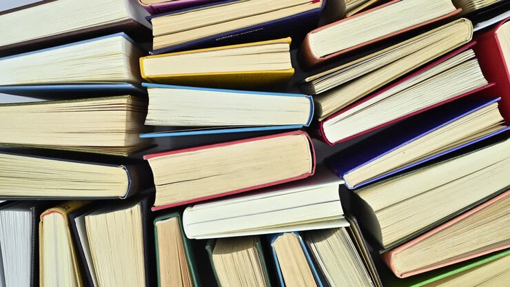 Pile of hardcover vintage books ordered filling the table move. Flat lay stop motion