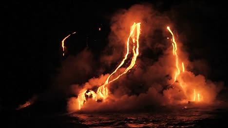 spectacular nighttime lava flow from a volcano into ocean