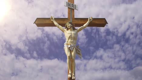 Lord-Jesus-statue-with-timelapse-cloud-background-and-sunshine