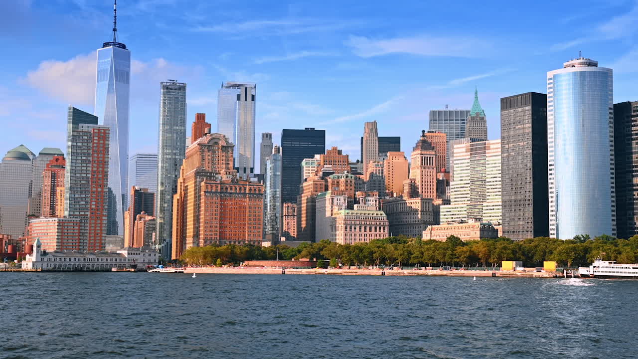 Diverse buildings in the skyline of modern New York, USA. View on the city waterfront from a boat travelling by the river
