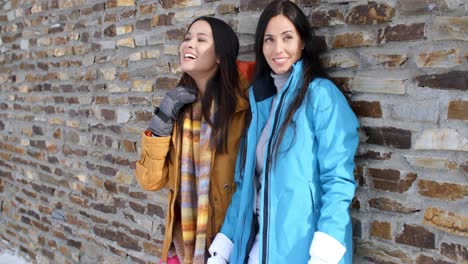 Laughing-twins-in-jackets-and-glove-near-wall