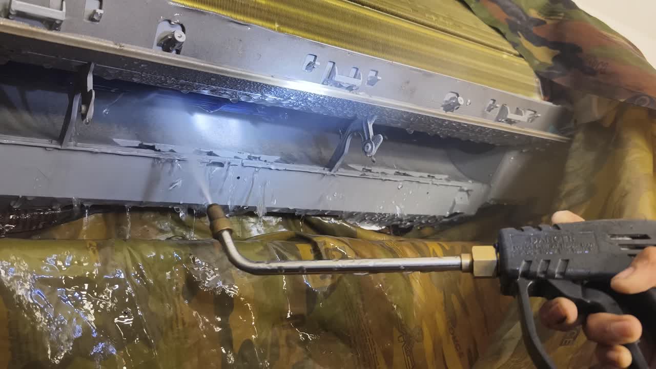 limpieza de una unidad de aire acondicionado con un chorro de agua