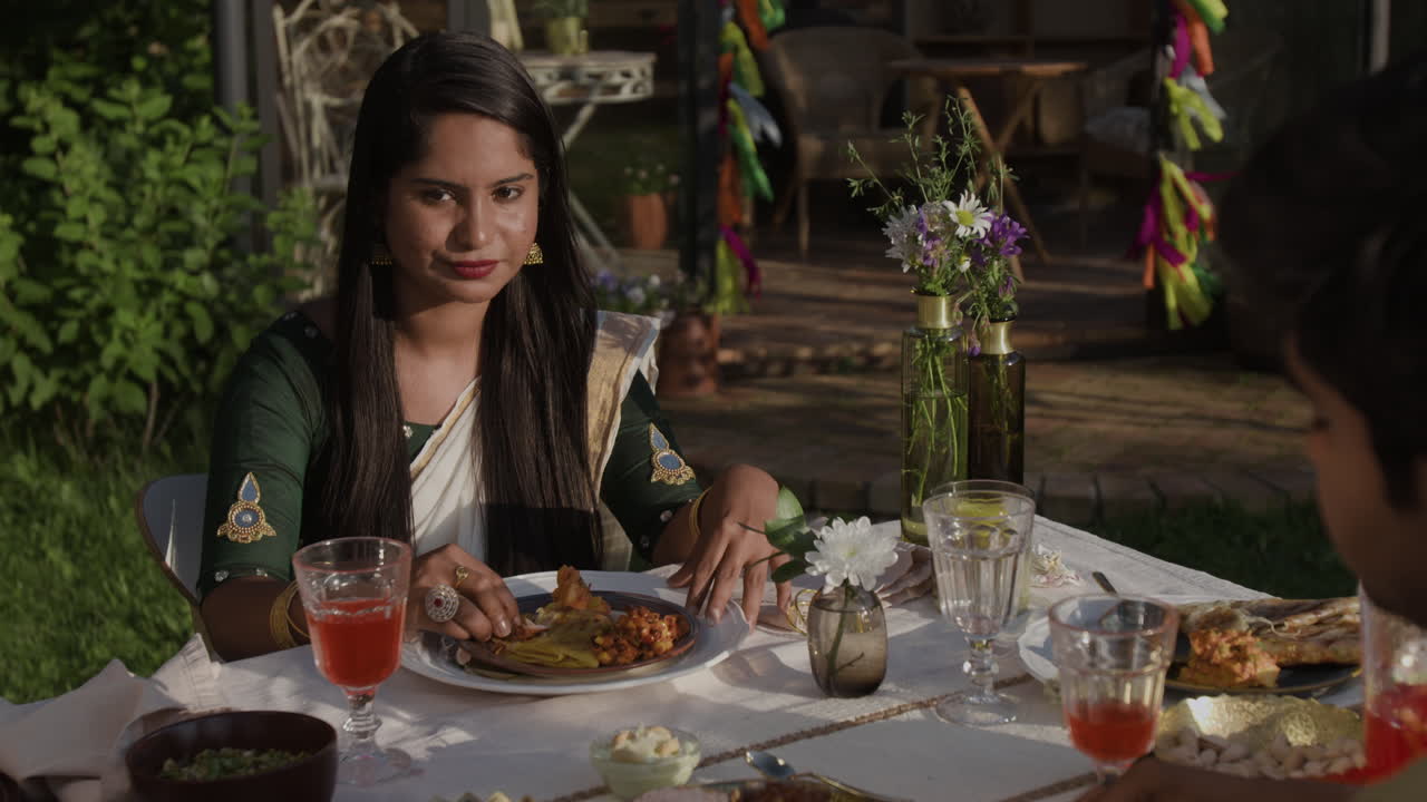 People Enjoying an Outdoor Traditional Indian Dinner