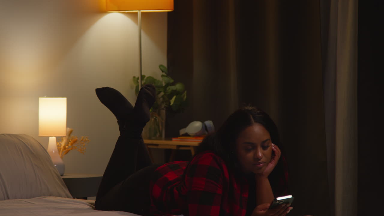 Woman Using Phone in Bed at Night