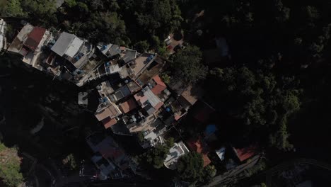 Forward-aerial-top-down-view-of-small-Rio-de-Janeiro-favela-Chacara-on-the-slopes-of-the-Two-Brothers-mountain-next-to-the-bigger-Vidigal-shanty-town