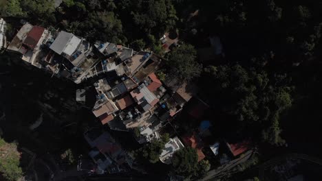 forward aerial top down view of small rio de janeiro favela chacara on the slopes of the two brothers mountain next to the bigger vidigal shanty town