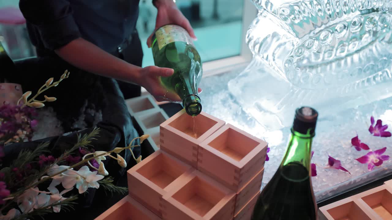 Women Pours Rice Wine Into a Masu Box