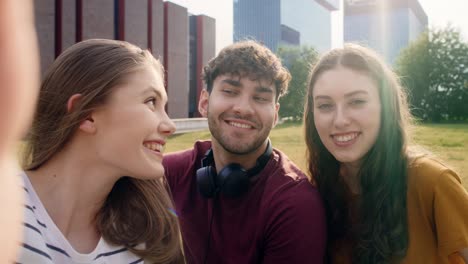 portrait of three caucasian university students sitting outside the university campus