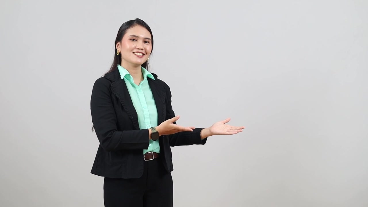 Attractive, professional Asian woman uses hand to make 3 different points