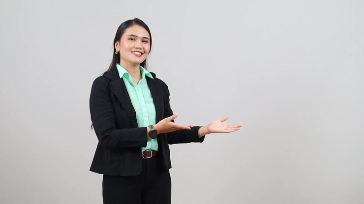 Attractive, professional Asian woman uses hand to make 3 different points
