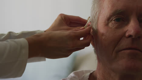 nurse helping a senior man in a retirement home