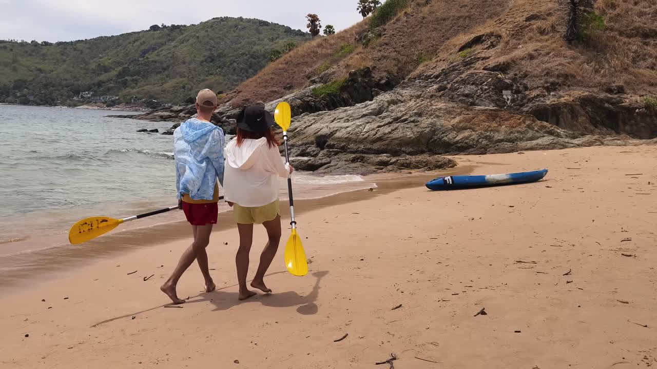 Couple Kayaking on a Tropical Beach