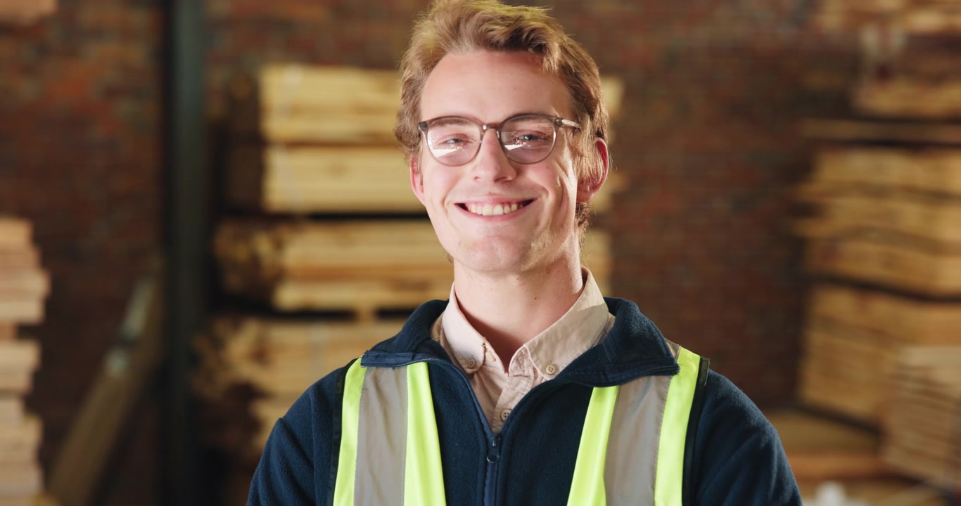Young Male Warehouse Worker Smiling at Camera