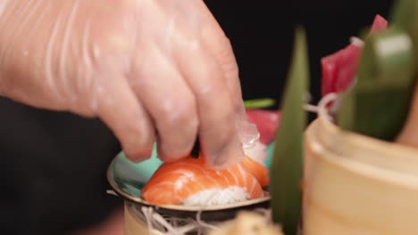 garnishing fresh tuna with delicious black caviar -close up